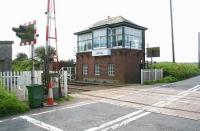 The signal box at Dunragit on 31 May 2007. View is south over the level crossing with the remains of the former station (closed June 1965) just off picture to the right.<br><br>[John Furnevel 31/05/2007]