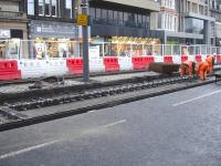 Workmen in the process of bonding insulating blocks onto rails along Princes Street, near The Mound, to prevent stray  electrical traction return currents.<br><br>[David Pesterfield 08/11/2011]