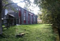 Platform view at Ballindalloch in September 2004, looking south west towards Grantown-on-Spey. The old station, which closed to passengers in October 1965, is seen here in use as a hostel. <br><br>[John Furnevel 12/09/2004]