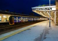 As dusk falls on 4 November 2011, a Northern 158 waits in one of the two middle roads between platforms 1 and 2 at Sheffield while carrying out a shunt move at the south end of the station.<br><br>[John McIntyre 04/11/2011]