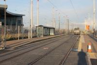 Almost ready for passengers, with a road sweeper on tidying duties, is the new two platform terminus at Starr Gate alongside the <I>Flexity Trams</I> depot. The previous tram stop was a simple ground level shelter on the single line turning circle but trams will now reverse here to go north again with separate platforms for alighting and boarding. <br><br>[Mark Bartlett 26/10/2011]