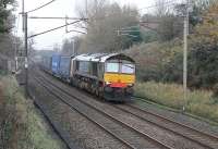 DRS 66421 hustles the 4M44 Mossend to Daventry containers south towards the closed station at Barton and Broughton. On this gloomy November afternoon the dark blue livery appeared almost black.<br><br>[Mark Bartlett 15/11/2011]