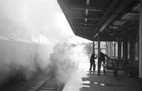 Men behaving badly. Messing around on the platform at Kirkcudbright in March 1963. View north from the buffer stops towards the locomotive shed, with the goods shed visible on the left through the smoke. <br><br>[R Sillitto/A Renfrew Collection (Courtesy Bruce McCartney) 09/03/1963]