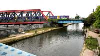 View west from Scrubs Lane towards Mitre Bridge over the Grand Union Canal in July 2005. The train is a Silverlink West London Line service from Clapham Junction to Willesden Junction which is about to bear left at Mitre Bridge Junction, following which it will cross over the WCML to reach the high level station [see image 5193]. Beyond the wall on the left are the various yards and rail facilities located around Old Oak Common. (The geese on the left gave me a bit of a hard time getting past!) <br><br>[John Furnevel 22/07/2005]