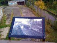 Looking over the platform remains from the former Newhaven Station booking office [see image 36401] on 25 September 2011. View is east towards Leith North and the docks. The large picture board shows a photograph taken from the same spot in the early sixties.<br><br>[Grant Robertson 25/09/2011]