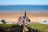 A panoramic view showing the 'Cliff Lift' and pier at Saltburn in the summer of 2009, looking out to sea from the top station alongside the town's Marine Parade. [See image 36445] <br><br>[Brian Taylor 02/07/2009]