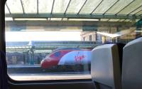 <I>Pendolino</I> 390018, newly arrived from Euston on a Glasgow service, stands in Platform 3 at Carlisle on 16 November. A Whitehaven service awaits its departure time in the bay alongside. The rear driving car is seen here from a Northern Class 158 in bay platform No.6.<br><br>[Mark Bartlett 16/11/2011]