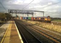 GB Railfreight 66734 thunders South on the WCML through Polesworth, Warwickshire, with a colourful container train on 4th November 2011. <br><br>[Ken Strachan 04/11/2011]