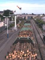 A long Class 37-hauled timber train heads east from Elgin in 1995. Following the demise of the Speedlink network in 1991, and the ill-fated Elgin/Keith-Coatbridge container service from 1991 to 1992, timber from Inverness to the Shotton paper mill was for several years the only regular freight traffic in this part of the world. By 2009 only occasional freight specials were serving the Inverness-Aberdeen corridor.<br><br>[David Spaven //1995]