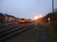 Dusk at Treherbert on 16 November, as 143623 waits to return to Cardiff on the rear of the 16.17 departure, with the floodlights highlighting the rails of the stabling sidings.<br><br>[David Pesterfield 16/11/2011]