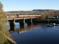 View north east from the 'new' road bridge over the River Leven at Dumbarton on 22 November 2011 as a westbound Class 320 crosses the river on the approach to Dalreoch station.<br><br>[John McIntyre 22/11/2011]