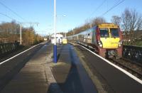 334040 pulls away from Dumbarton East on 22 November 2011 heading for Glasgow, just as 320308 leaves on a service to Balloch in the background. <br><br>[John McIntyre 22/11/2011]