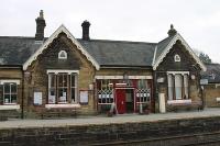 The main station building at Settle, on the Leeds platform, is in excellent condition and obviously well cared for if a little cluttered with signs, plaques and posters. Also mounted on the building is the mile post - 236 and a half miles from St Pancras. More quirkily, set in the alcoves on the gable ends of the building are two little figurines, one of Mickey and another of Minnie Mouse. <br><br>[Mark Bartlett 16/11/2011]