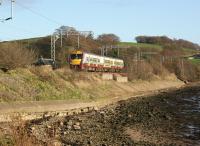 Helensburgh bound 334003 on the embankment alongside the River Clyde at Ardoch on the eastern approach to Cardross on 22 November 2011.<br><br>[John McIntyre 22/11/2011]