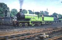 Scene in Dumfries shed yard on 13 June 1959 with special guest ex-Great North of Scotland Railway 4-4-0 No 49 <I>Gordon Highlander</I>. The locomotive was preparing to head for St Enoch with the returning SLS <I>Golden Jubilee Special</I>, which had originated that morning from Buchanan Street.<br><br>[A Snapper (Courtesy Bruce McCartney) /06/1959]
