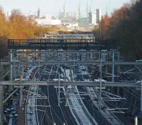 A sight to warm your heart, four tracks running east from the site of Arkleston Junction towards Glasgow on 27 November 2011. The reduction to three tracks can just about be made out in the distance. Glasgow and the tower of the University of Glasgow can be seen on the horizon. [See image 16537] for the two track layout.<br><br>[Ewan Crawford 27/11/2011]