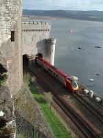 A Holyhead bound Voyager emerges from the Conwy tubular bridge and runs beneath the ramparts of the castle with the estuary behind. [See image 31961]<br><br>[Mark Bartlett 26/11/2011]