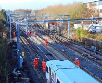 View looking west over a tamper working at Cardonald Junction. The new third line runs up the centre and the Deanside Branch turnout is in the background. [See image 29544] for a view of the same location in 2010.<br><br>[Ewan Crawford 27/11/2011]