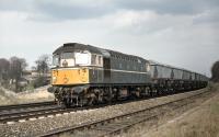 Birmingham Type 2 No. D5301 with its train of empty MGR coal hoppers from Cockenzie Power Station cautiously approaches Monktonhall Junction in April 1970. It will diverge onto the chord into Millerhill Yard and its final destination at Monktonhall Colliery.<br><br>[Bill Jamieson 21/04/1970]