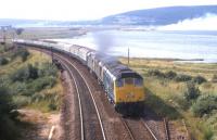 A triple-headed southbound train takes a run at the 1 in 60 gradient shortly after passing Millburn Junction, Inverness, in the summer of 1971. With 11 coaches, a restaurant car third from the front, and a Travelling Post Office at the rear, this looks like the 16.35 Inverness-Edinburgh.<br><br>[Frank Spaven Collection (Courtesy David Spaven) //1971]