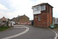 The signal box standing alongside the level crossing and former station at Low Row on the Newcastle and Carlisle line near Brampton, Cumbria, looking south on 6 May 2006. What at first glance appears to be the signal box nameboard in fact states 'Railway Inn [100 Yds]'. [See image 52631]<br><br>[John Furnevel 06/05/2006]