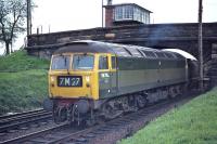 Tinsley based Brush Type 4 No. 1876 is well away from its usual haunts as it passes under the road bridge immediately south of Strawfrank (now Carstairs South) Junction on Saturday 23 May 1970 with train 7M27, the 08.25 Larbert - Wallerscote soda ash empties. [See image 39585]<br><br>[Bill Jamieson 23/05/1970]