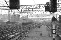 Class 303 EMU unit 014 arrives at Glasgow Central in March 1974 with other stock stabled in the carriage sidings in the background.<br><br>[John McIntyre 26/03/1974]