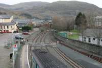 The <I>'Stop - Await instructions'</I> sign implies that it is still possible for trains to continue beyond Blaenau Ffestiniog towards Maentwrog Road on the old Bala line but in fact the buffers are in place, but just out of sight, beyond the loop points. View from the footbridge, over a newly arrived service from Llandudno, with the narrow gauge tracks on the right.<br><br>[Mark Bartlett 01/12/2011]