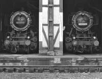 The straight shed at Rottweil was accessed by means of a traverser, presumably as a space saving measure. A pair of class 50 2-10-0s, Nos. 051 681 and 051 430 photographed peeping out of the shed in September 1974.<br><br>[Bill Jamieson 04/09/1974]