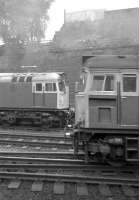 A Class 27 waits to depart from Glasgow Queen Street in March 1974 as another passes in the foreground on the rear of an Edinburgh-bound push pull service.<br><br>[John McIntyre /03/1974]