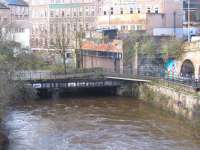 Looking west along the River Kelvin from Great Western Road on 2 December 2011. In the middle distance is the bridge that carried the Glasgow Central Railway over the river and on which the platforms of Kelvin Bridge station once stood. To the right of the bridge the line passed below Caledonian Crescent, then ran in the open for about 100 yards, before entering the long tunnel running below Great Western Road, eventually emerging at Botanic Gardens station [see image 10426]. <br><br>[John McIntyre 02/12/2011]