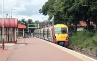 A train for Airdrie stands at the terminus at Balloch in July 2005. Visible above the train in the background is part of the former station on the north side of Balloch Road.  The 1850 station was replaced by the current terminus in April 1988 and the old building was subsequently put to use as a tourist information centre [see image 21711].<br><br>[John Furnevel 28/07/2005]