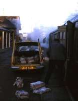 The photographer takes a break from his job as Senior Railman at Tain in 1974 to capture this early morning scene showing newspapers being offloaded from the 06.15 Inverness-Wick/Thurso train.<br><br>[David Spaven //1974]