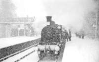 The SLS/BLS Joint Easter Railtour, running as <I>Scottish Rambler No 2</I>, photographed during heavy snow at Killin Junction on 12 April 1963. CR123 had brought in the train from Glasgow Central via the C&O and was about to hand over to Perth shed's Standard class 4 no 80093 for a trip to Killin and Loch Tay. The branch locomotive can just be made out waiting over on the left. For the scene before the snow storm [see image 6536].<br><br>[R Sillitto/A Renfrew Collection (Courtesy Bruce McCartney) 12/04/1963]