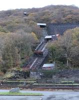 The famous Dinorwic Quarry engines operated at various 'levels' in the huge slate quarry, with the different sections each having their own tiny engine sheds and servicing points. The levels were linked by this series of inclined planes. The lowest one has had track reinstated and some slate wagons are on static display mounted on the lift wagons as seen here. In the foreground are the tracks of the Llanberis Lake Railway, which follows part of the route of the old 4' gauge Padarn Railway. <br><br>[Mark Bartlett 02/12/2011]
