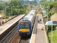 An early afternoon train from Glasgow Queen Street heading for Falkirk Grahamston calls at Greenfaulds on a fine summer's day in July 2006. The station, which is also served by trains on the Motherwell - Cumbernauld route, opened in May 1989.<br><br>[John Furnevel 26/07/2006]