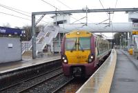 A morning Helensburgh Central - Edinburgh Waverley service arrives at Airdrie on a wet 10 December 2011.<br><br>[John Steven 10/12/2011]