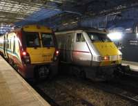 334037 and 82207 stand at Edinburgh Waverley during the early afternoon of 10 December 2011.<br><br>[John Steven 10/12/2011]