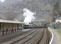 Narrow gauge Fairlie locomotive <I>Merddyn Emrys</I> arrives in Blaenau Ffestiniog from Porthmadog, as seen from the front of an ATW Sprinter waiting to depart for Llandudno. I hadn't expected to see any steam trains but was assured by a local resident that one would appear shortly before the branch train left. However, it was connecting into private road coaches rather than the Conwy Valley service train.<br><br>[Mark Bartlett 01/12/2011]