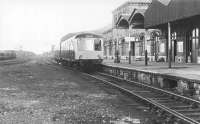 An afternoon DMU service for Carlisle waits in the bay platform at a 'pre-rationalisation' Whitehaven station in 1972. (The platform serving through trains to Barrow and beyond is on the other side of the station building.) Opened in 1874 as a replacement for the original 1847 terminus built a short distance to the south, it carried the name Whitehaven Bransty until the suffix was officially dropped in 1968 (although the signal box in the background still carries the name). [See image 19911]   <br><br>[John Furnevel 23/04/1972]