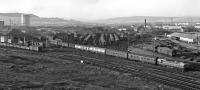 A BRCW Type 2-hauled train from the north runs round Rose Street Curve in 1967, prior to reversing back into the southbound platforms at Inverness station. The substantial footprint of railway activities in the background includes the carriage cleaning depot and Needlefield Yard, with 'biscuit' containers beside the rail-served shed.<br><br>[Frank Spaven Collection (Courtesy David Spaven) //1967]