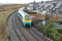 Slowly negotiating the tight checkrailed curve, 175105 comes off the Llandudno branch at the main line junction on a service for Manchester Piccadilly. The gantry on the left marks the Conwy road tunnel and this image was taken from the modern road bridge that replaced a very congested level crossing on the old road to Conwy [see image 37693].<br><br>[Mark Bartlett 29/11/2011]