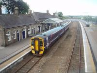 158736, on a short working from Aberdeen, waits at Inverurie before returning there. View north from the road overbridge at the south end of the station. <br><br>[Mark Bartlett 30/06/2011]