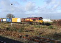 DBS 66020 comes off the Oxford line and runs east through Didcot on 15 December with a container train.<br><br>[Peter Todd 15/12/2011]