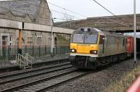 92041 <I>Vaughan Williams</I> speeds a rake of containers south past the remains of Carnforth's main line platforms in the last bit of the daylight on 23rd December 2011<br><br>[Mark Bartlett 23/12/2011]