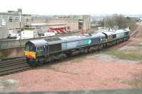 A pair of DRS Class 66 locomotives running from the Grangemouth refinery sidings towards Fouldubs Junction on the afternoon of 20 December 2011. The locomotives are passing the site of the former Grangemouth station which closed to passengers in 1968. Reinstatement of passenger services to the town is the subject of ongoing lobbying, not least in view of the number of passenger trains currently using the branch for 'turnback' purposes each day [see image 35008].<br><br>[John Furnevel 20/12/2011]