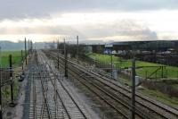 Boxing Day view south at Farington Junction and a pall of smoke still drifts across the line from the fire that started five days previously in the nearby business park. This caused the temporary closure of the WCML at the time [See image 2749]<br><br>[Mark Bartlett 26/12/2011]