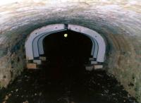 A view through the tramroad tunnel under the drive at Calke Abbey in August 2010 [see image 36668]. View looks towards Ticknall. Notice the almost circular bore at the far end, and the breadth of the hoops - there was a junction inside the tunnel, requiring this (quarry) end to be wider.<br><br>[Ken Strachan /08/2010]