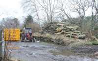 Looking east along the trackbed of the SB&B at Broughton towards Peebles on Boxing Day 2011. The remains of the old station have now become part of a fenced and gated farm yard. The surviving island platform, seen here covered in logs, was created in 1896, giving Broughton 3 through platforms, the southernmost being used by trains on the new Talla Railway running south to Victoria Lodge.<br><br>[John Furnevel 26/12/2011]