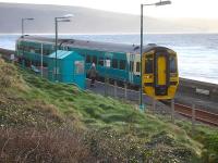 158823 picks up two passengers at Llanaber Halt, north of Barmouth, on 7 December 2011. The train will depart as the 13.55 service forward to Pwllheli (10.09 ex-Birmingham International).<br><br>[David Pesterfield 07/12/2011]